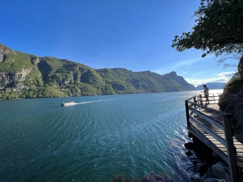 Norwegian fjord with boat and wooden dock