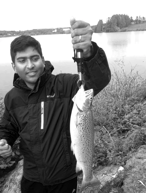 Suganthan with a fresh catch by the lake